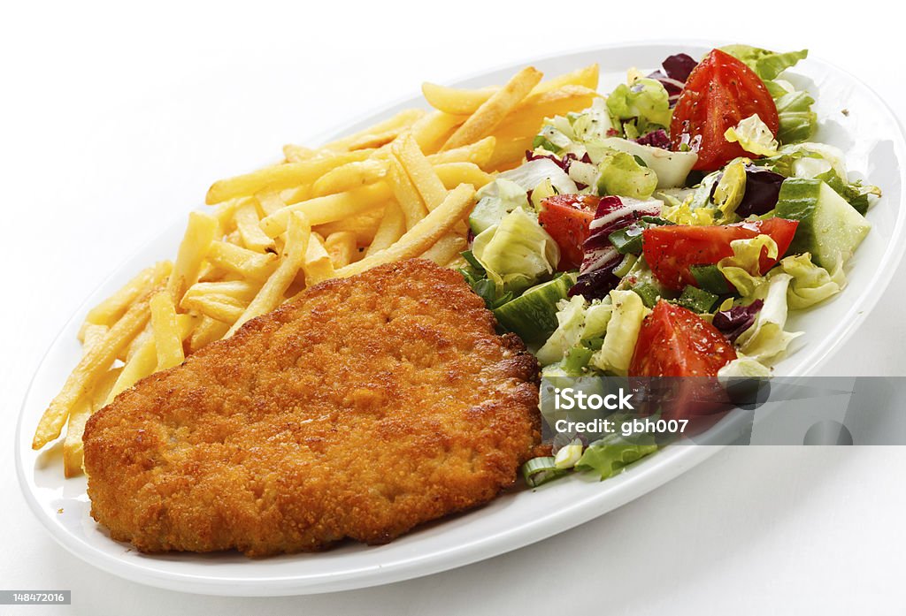 Fried pork chop and vegetables Fried pork chop with French fries and vegetables  Color Image Stock Photo