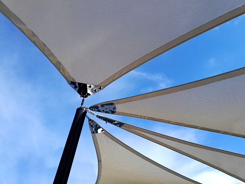 Sun shade sails with sky background
