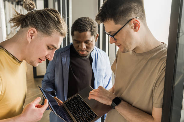 istock Team is looking for bug fixes in the phone application. Programmers working in the office of a software development company. Coding technologies, site design. Successful diverse Teamwork 1484731807