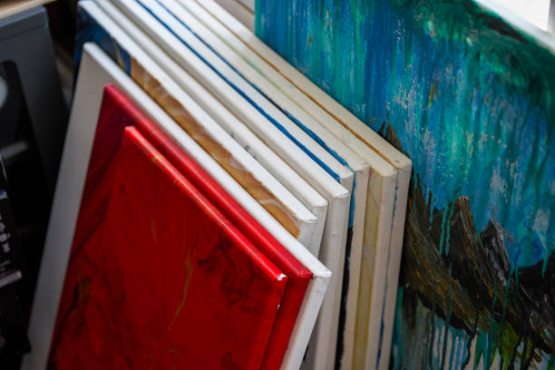 Frames and works stacked in an oil painting studio