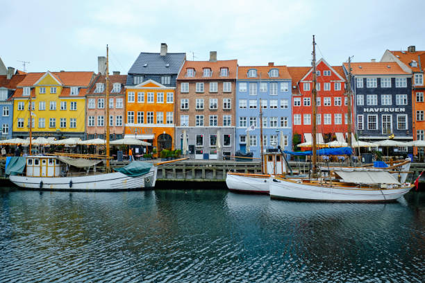 Multicolored houses along the canal in Nyhavn harbor, Copenhagen, Denmark stock photo
