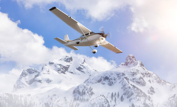 istock Small Airplane flying near Sky Pilot Mountain covered in Snow. Adventure Composite 1484733352