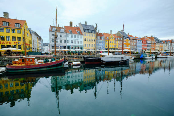 Multicolored houses along the canal in Nyhavn harbor, Copenhagen, Denmark stock photo