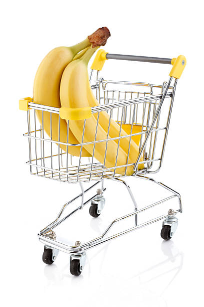 istock Shopping trolley with bananas on white 148473360