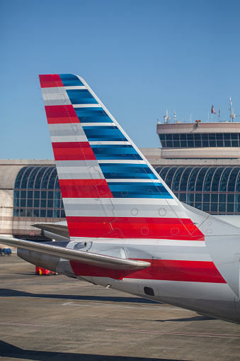 Tail of American Eagle Embraer E175LR aircraft at Charlotte Douglas International Airport in April 2022.