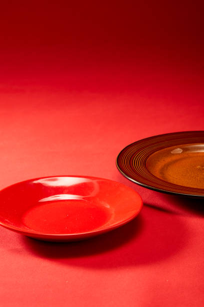 istock A red dinner plate lies under a red leather background cloth 1484736910