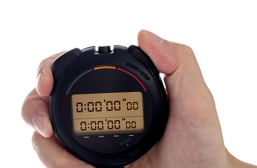 Human hand holding a digital stopwatch