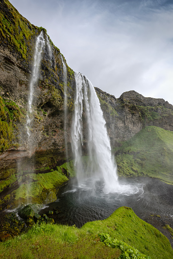 Iceland  Seljalandsfoss Waterfall under summer skyscape. Famous icelandic natural landmark close to the Route 1. The waterfall has a height of around 60m and is part of the Seljalands River, which has its origin in the volcanic glacier of Eyjafjallajökull. Seljalandsfoss  Waterfall, Route 1, Southern Iceland, Iceland, Nordic Countries, Northern Europe