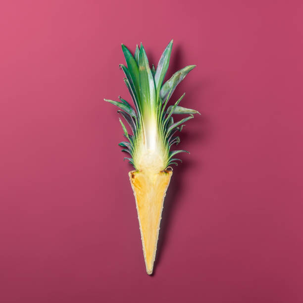 istock Creative summer concept. Cut pineapple in a waffle cone on a red background. 1484738781