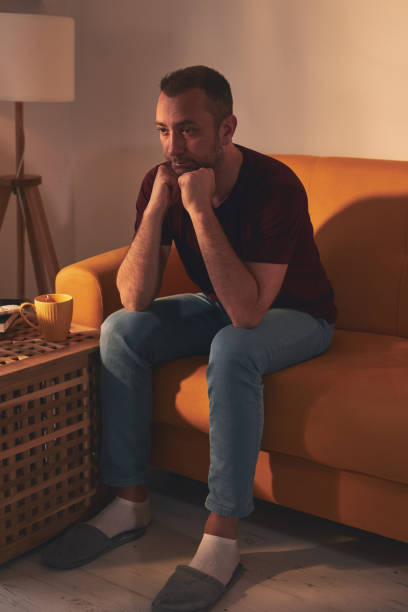 istock Bored man with lethargy and apathy sitting at home alone. 1484740628