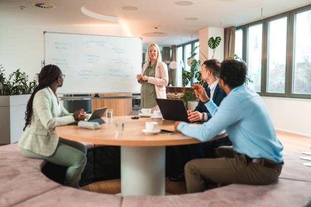 istock Confident Businesswoman Leading Team in Creative Planning Session 1484741029