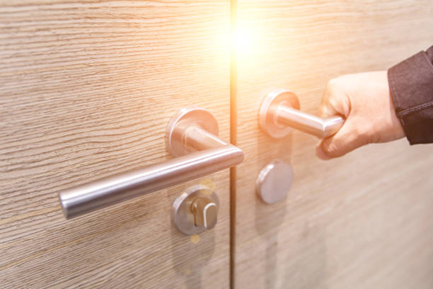 istock Hand opening closed wooden door 1484744381