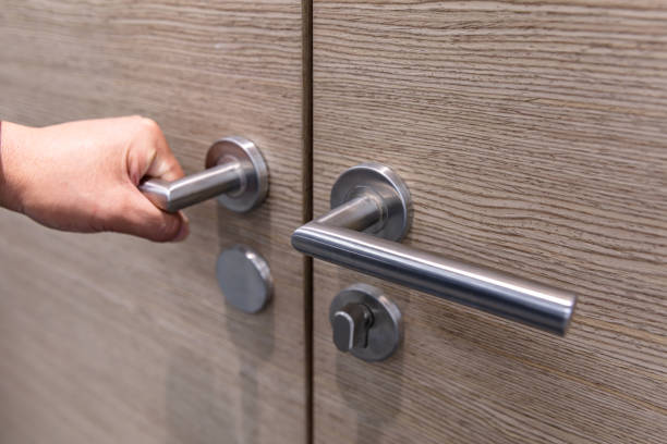 istock Hand opening closed wooden door 1484744405