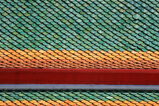 Two Layers of Colorful Tiles on Thai Temple Roof at Bangphai wat in Nonthaburi province, Thailand