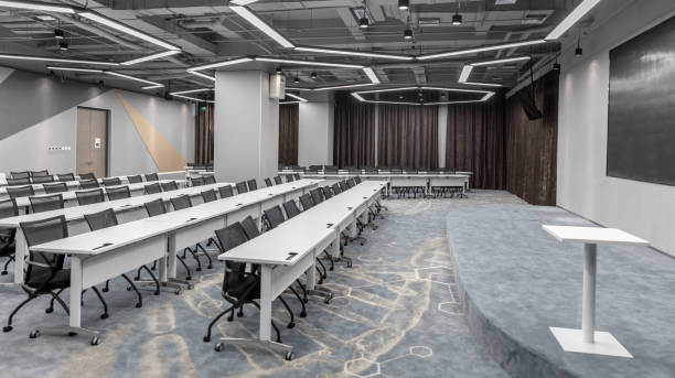 istock Brightly lit empty classroom with neat tables and chairs 1484744705