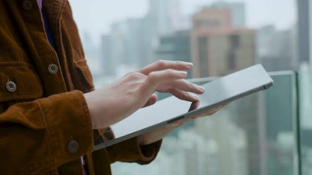 Architects using a digital tablet while inspecting a building site on skyscraper.
