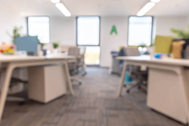 istock Blurred background of corridor in modern office interior 1484745857