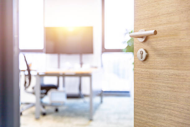 istock Open wooden door of modern office 1484748016