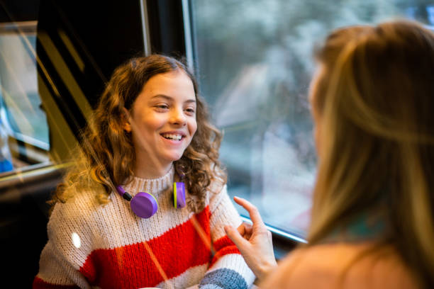 istock Happy girl travelling on train with mother 1484751156