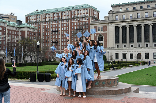 New York City, United States, April 7, 2023 - Group of happy college students celebrating their graduation day at Columbia University in New York with a group photo