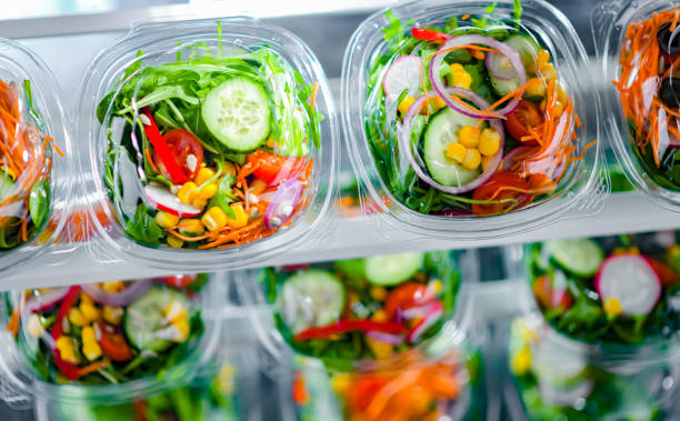 istock Boxes with pre-packaged vegetable salads in a commercial fridge 1484753832