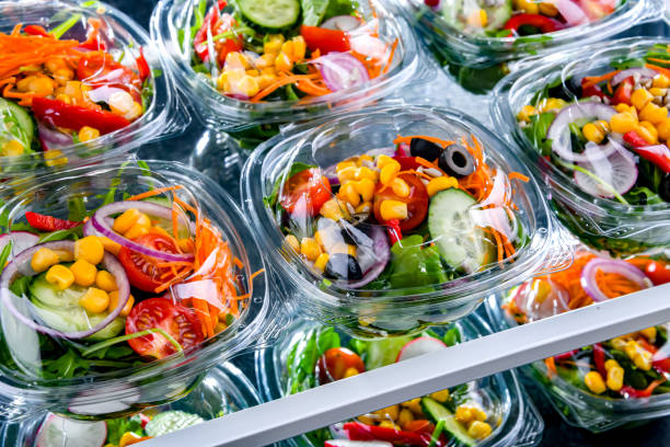istock Boxes with pre-packaged vegetable salads in a commercial fridge 1484753895