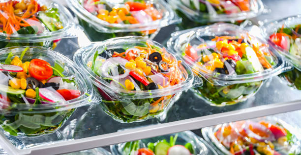 istock Boxes with pre-packaged vegetable salads in a commercial fridge 1484753944
