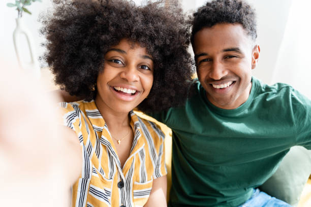 istock Smiling black cuple taking selfie on smartphone 1484755024