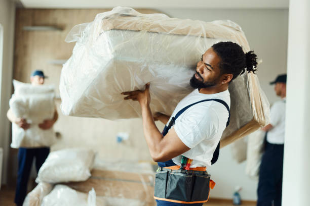 Young black mover carrying furniture in a new apartment. African American male mover carrying furniture in the apartment. movers stock pictures, royalty-free photos & images