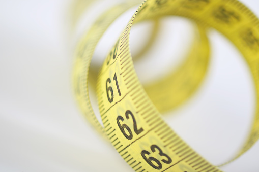 Close up of measure tape on white background ,Dieting Concept