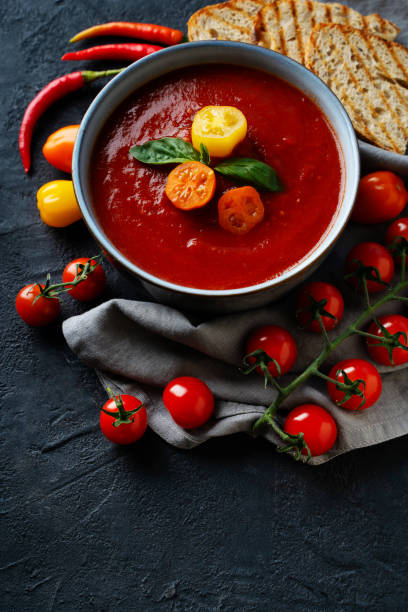 istock Gazpacho soup with tomato and ingredients on black background 1484755882