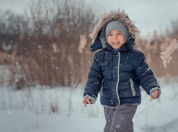 istock Cute little boy on a snowy field. 1484757227
