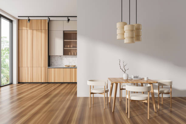 istock Light kitchen interior with eating table and cooking area near panoramic window 1484758559