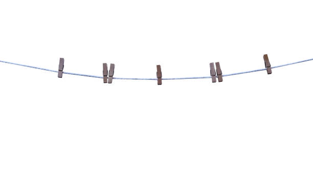 istock Blank wood clothes peg hang on brown string line isolated on white background,clipping path 1484758791