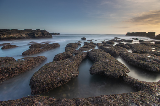 sunset in rocky Beach in Mengening beach Bali,mengening beach is one of the most popular tourist destination in Bali