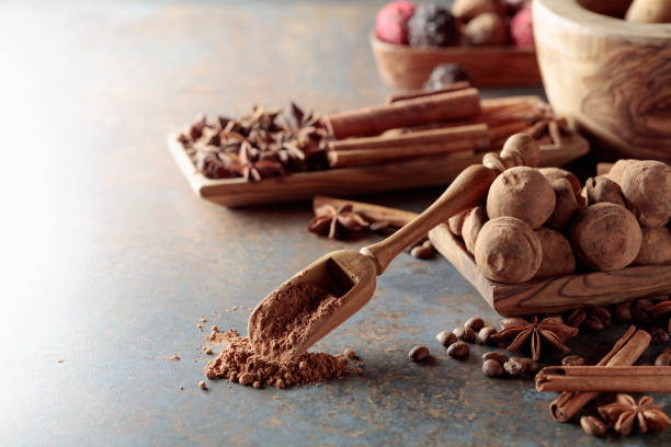istock Chocolate truffles and spoon with cocoa powder. 1484758843