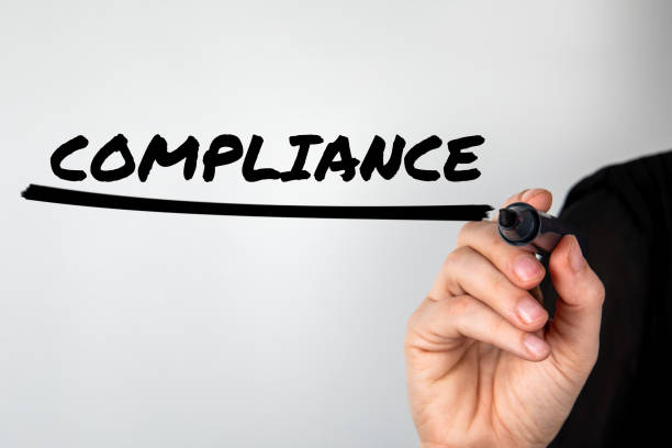 istock Compliance concept. Woman's hand with a black marker writes on the screen 1484758982