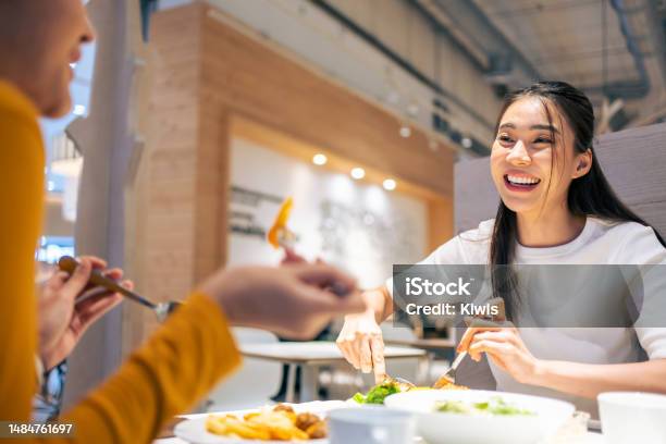 Asian Beautiful Women Having Dinner With Friend In Restaurant Together Attractive Young Girl Feeling Happy And Relax Having Fun Talking And Eating Food At Their Table In Dining Room In Cafeteria Stock Photo - Download Image Now