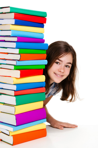 Back to school - girl peeking behind pile of books 