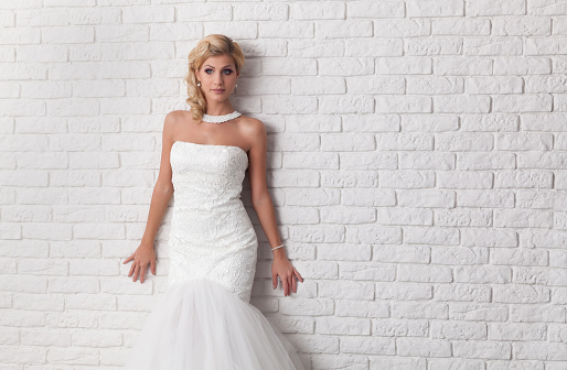 Lovely young woman wearing a white wedding dress.