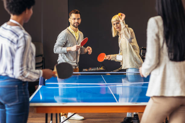istock Young people playing table tennis in the office at work 1484763775