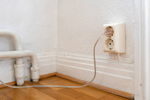 istock Old european electricity socket with cables on the wall 1484765690