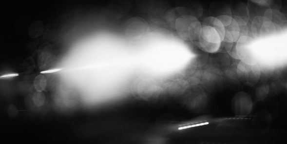 Light in the tunnel, abstract motion blurred bokeh light illuminating the mountain road entrance in Paris, France, monochromatic photo for mystery backgrounds