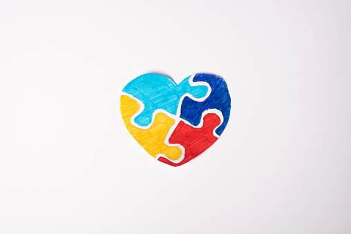 Colorful puzzle heart on white background. Multi-colored heart as a symbol of World Autism Awareness Day