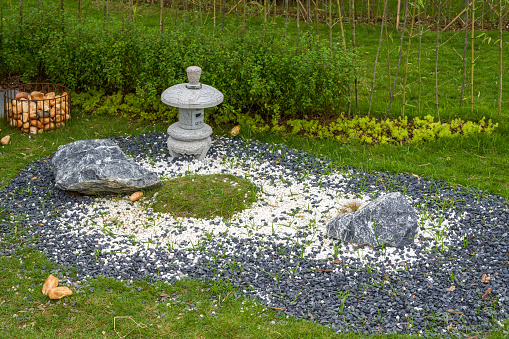 Walking path and zen-like white pagoda gravel landscape in Japanese garden