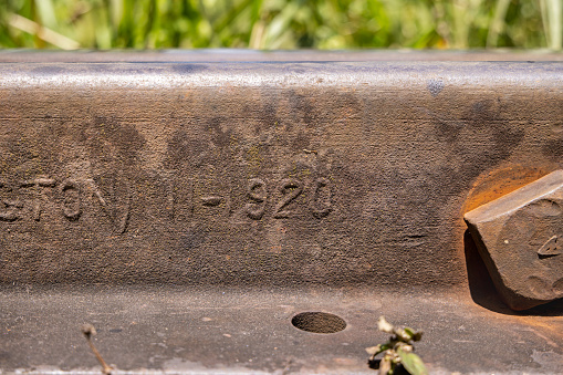 Old railroad track with the production year 1920 on the side at the railroad outside the Sri Lankan city Ella in the Uva Province