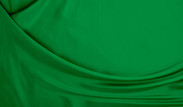 istock Black green satin dark fabric texture luxurious shiny that is abstract silk cloth background with patterns soft waves blur beautiful. 1484768970