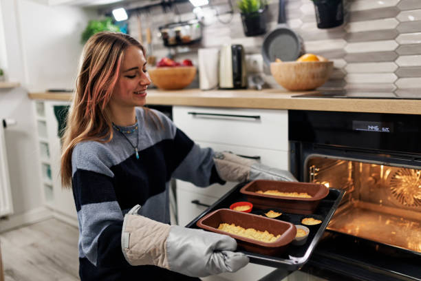 istock Generation Z teenagers baking and decorating tart cake 1484770589