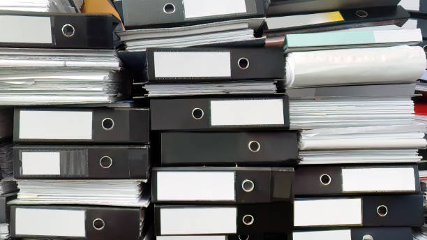 istock Close up large stack pile of file folders with paper documents in the office, business documents, messy, selective focus, filing, hardcopy 1484770833