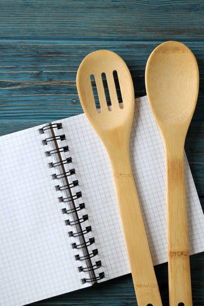 istock Empty recipe book and utensils on wooden table 1484771921